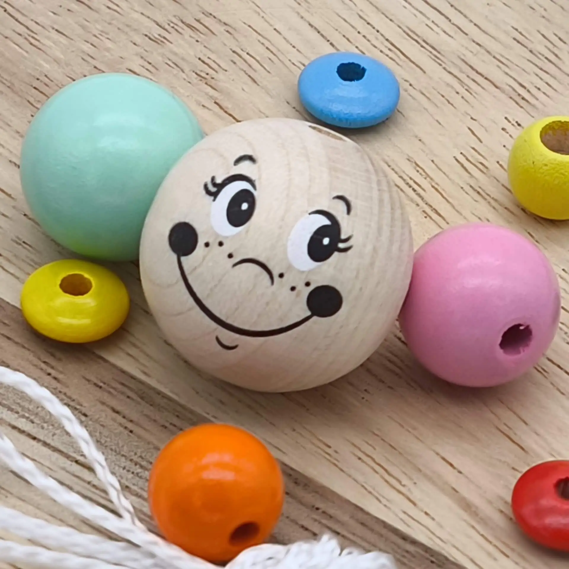 Wooden bead with "worm head" face